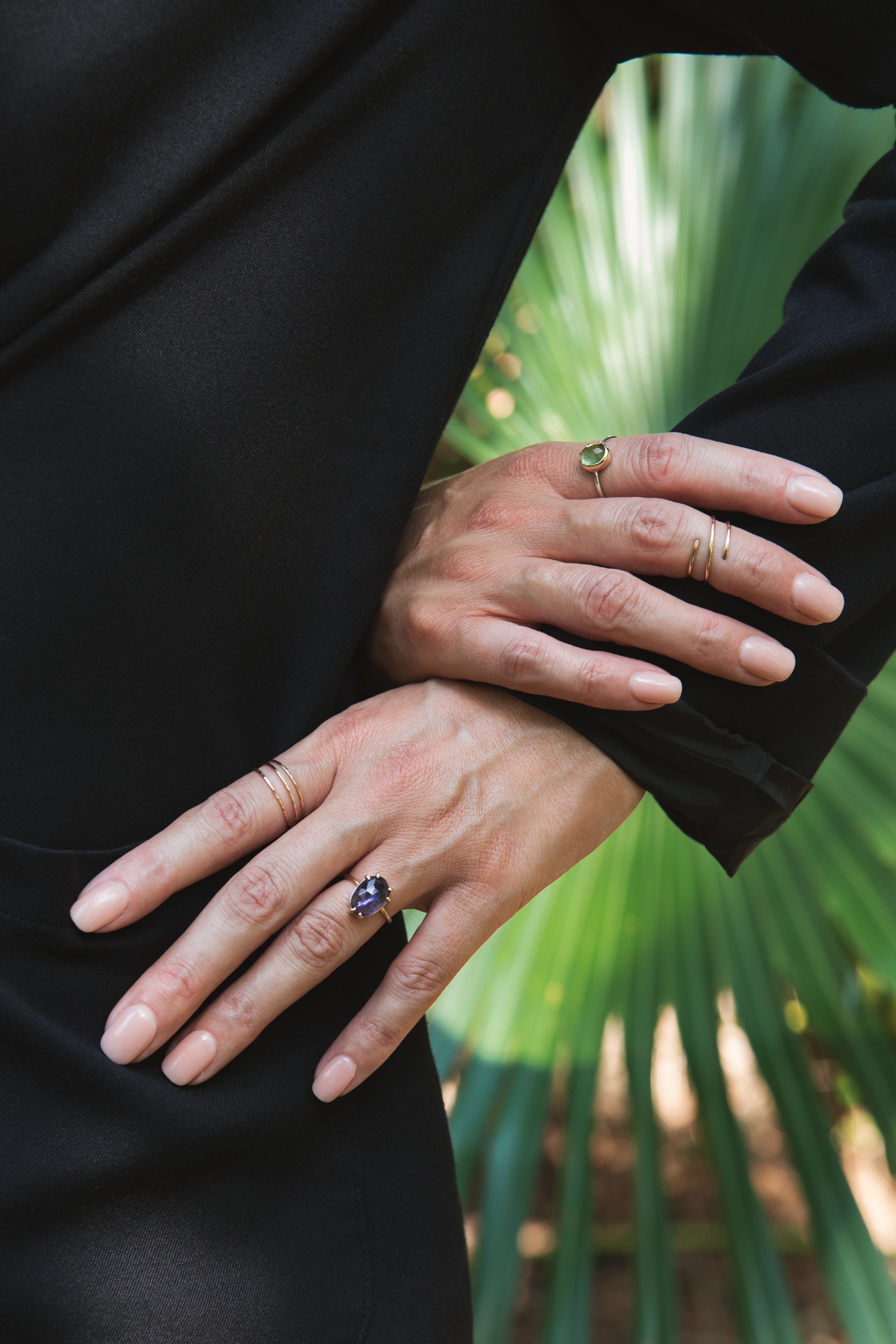 Woman's hands wearing Iolite Ring, Infinity Ring, Tourmaline Ring and Wrap Midi by Rockhaus Metals